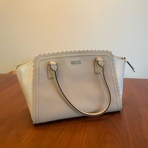 Beautiful white/cream bag with scalloped edges, pockets inside,Zipper on the top